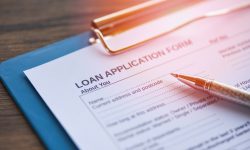 Loan application form with pen on paper / financial loan negotiation for lender and borrower on business document mortgage loan approval